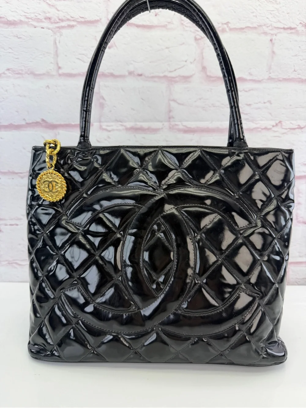 CHANEL Black Quilted Patent Leather Tote with Gold Medallion Charm